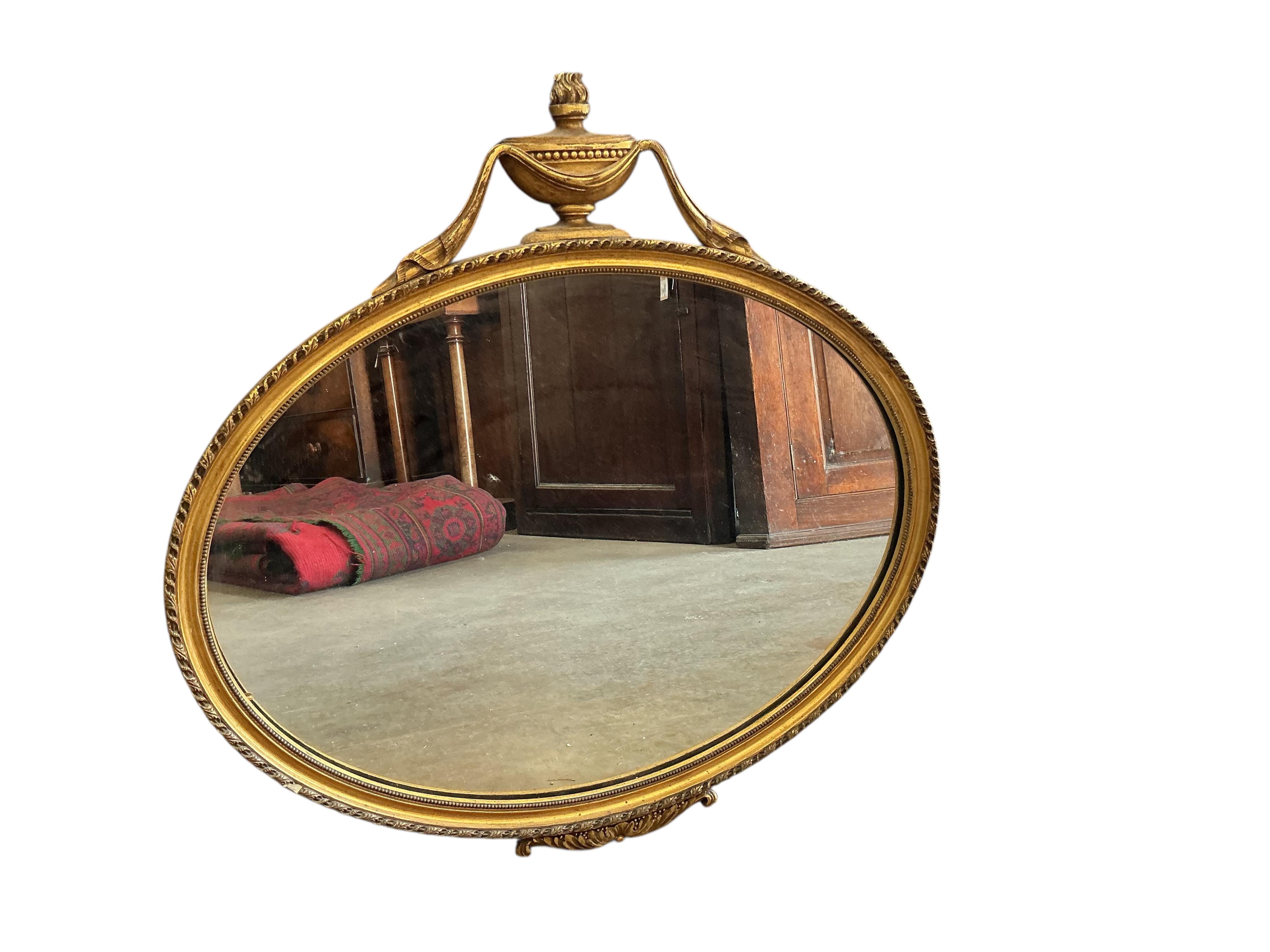 An Sheraton style oval gilt framed wall mirror, width 65cm, height 63cm